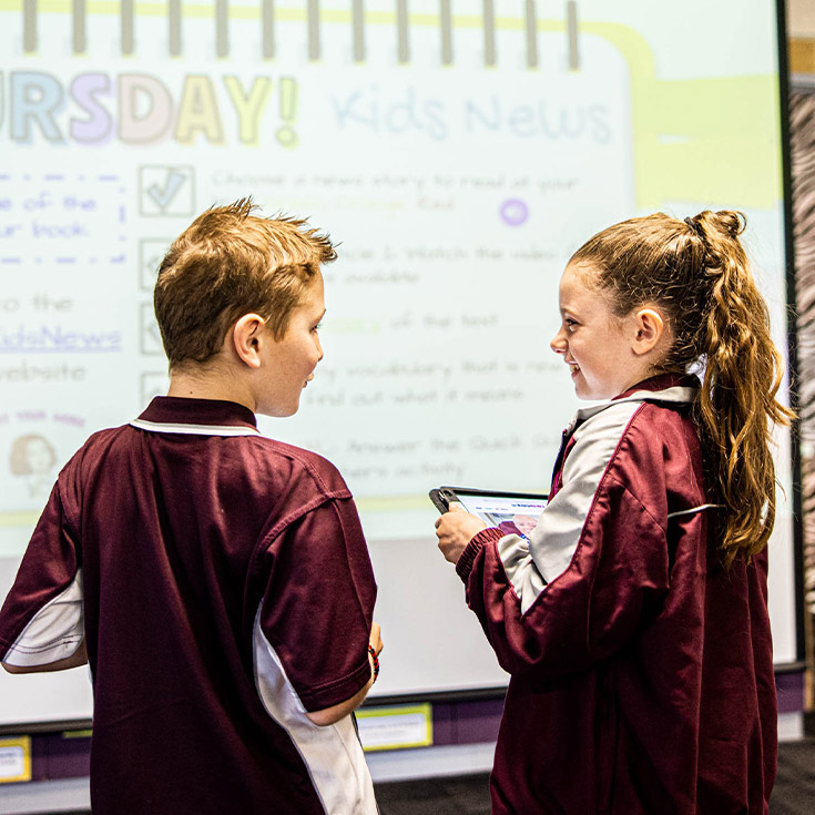 Students standing in front of a whiteboard at Mary Immaculate Primary School Quakers Hill