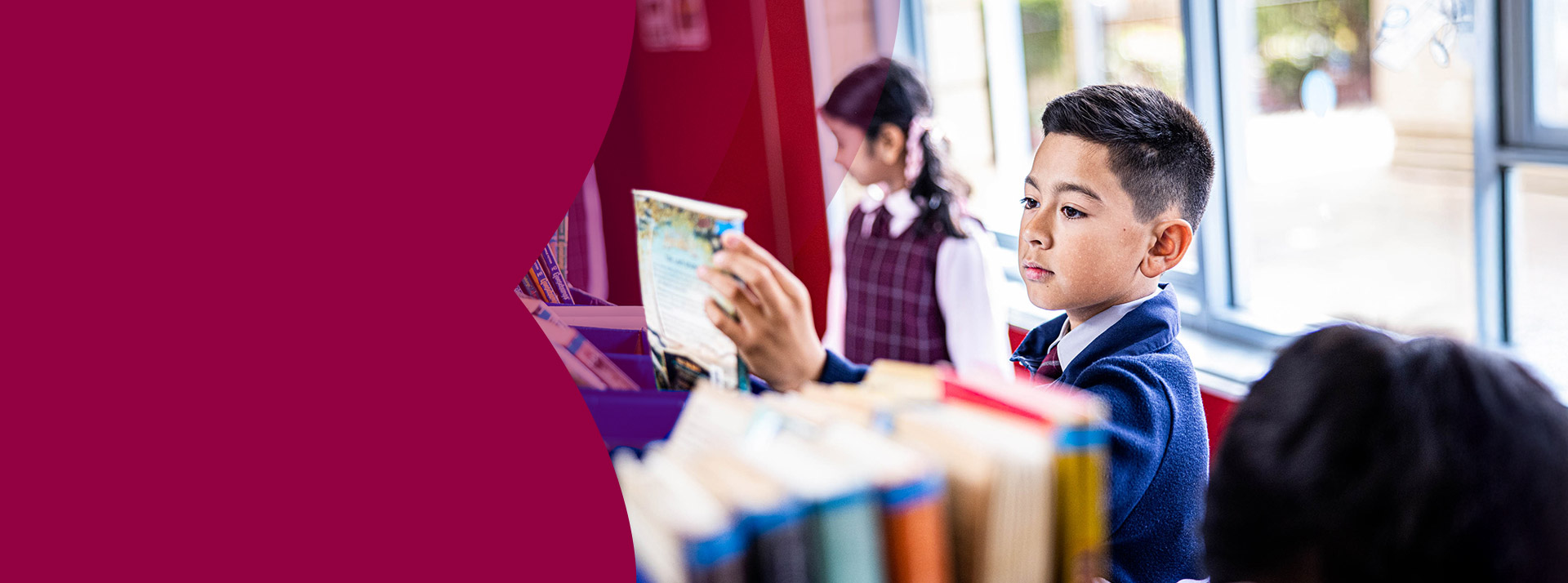 Student browsing books in the library at Mary Immaculate Primary School Quakers Hill