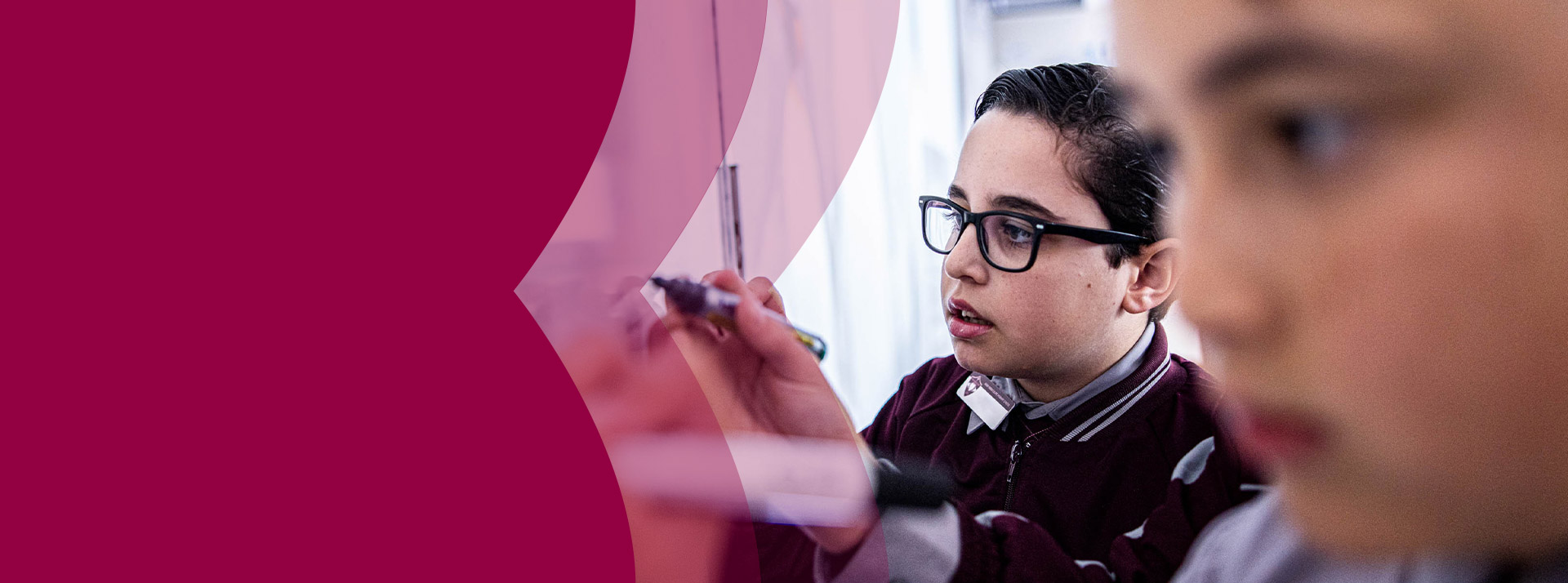 Students writing on the whiteboard in the classroom at Mary Immaculate Primary School Quakers Hill