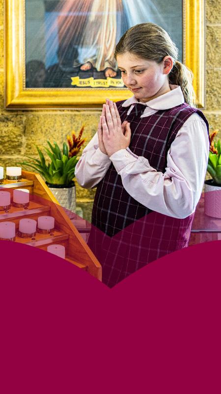 Student praying in church at Mary Immaculate Primary School Quakers Hill