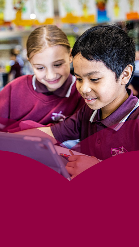 Students working together on their laptops in the classroom at Mary Immaculate Primary School Quakers Hill