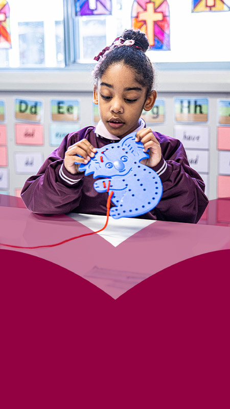 Student practising her threading skills in the classroom at Mary Immaculate Primary School Quakers Hill