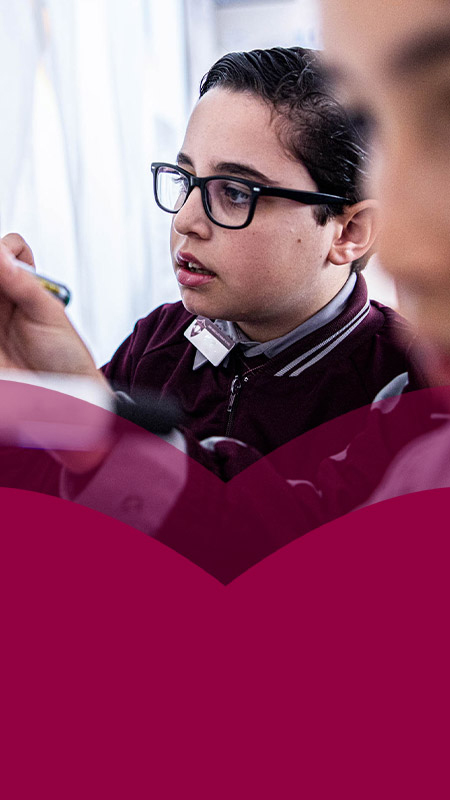Students writing on the whiteboard in the classroom at Mary Immaculate Primary School Quakers Hill