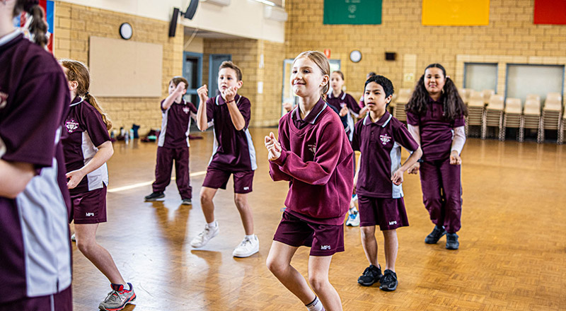Students dancing in the multi purpose area at Mary Immaculate Primary School Quakers Hill