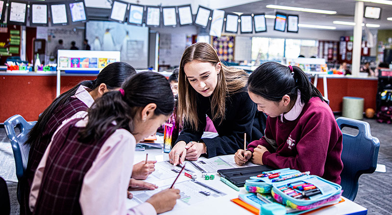 Teacher working with her students in the classroom at Mary Immaculate Primary School Quakers Hill