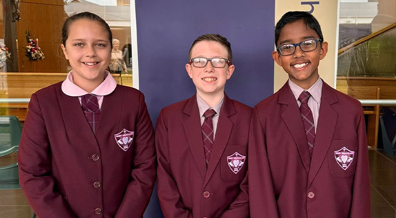 Students smiling together in their full school uniform at Mary Immaculate Primary School Quakers Hill