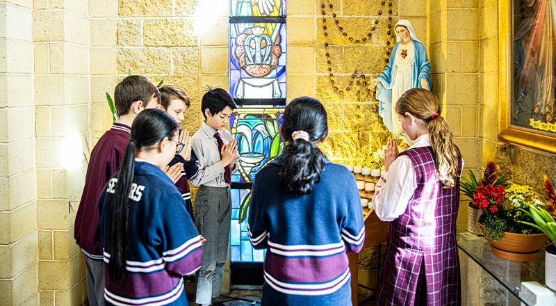 Students praying in church at Mary Immaculate Primary School Quakers Hill
