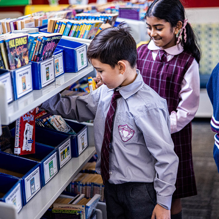 Students browsing books in the library at Mary Immaculate Primary School Quakers Hill
