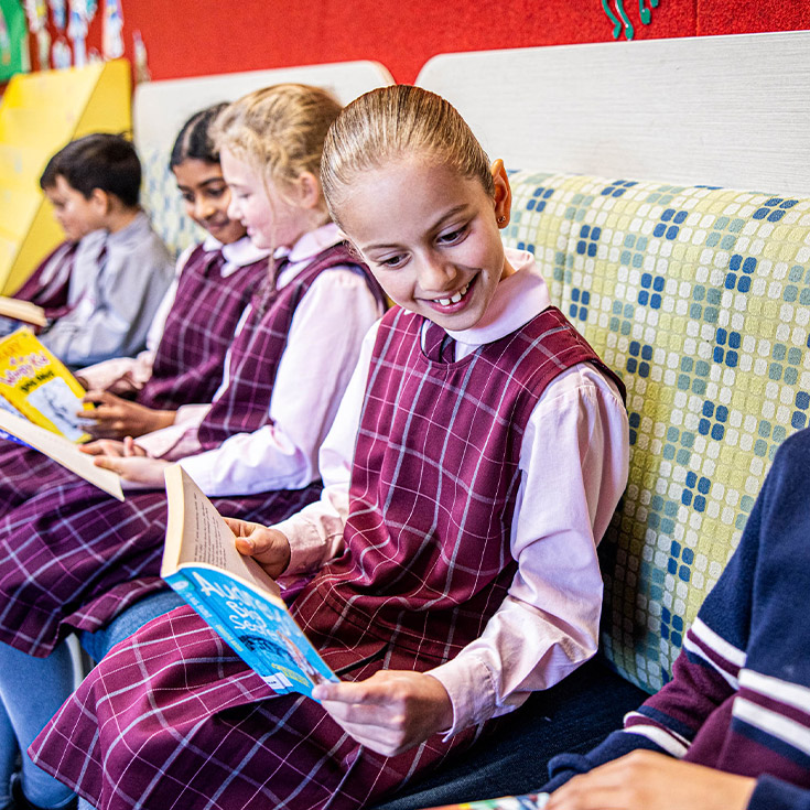 Students reading a book in the library in Mary Immaculate Primary School Quakers Hill